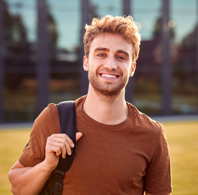 College Student on campus outside happy and smiling