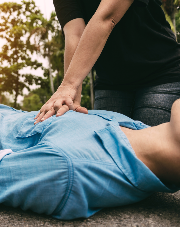 Person performing CPR on a test dummy during first aid course