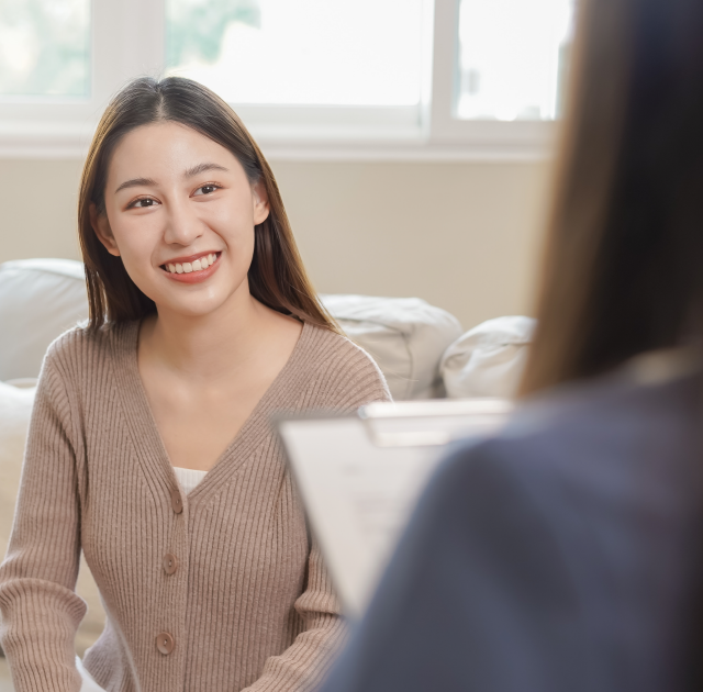 Looking over practitioners shoulder during client consultation with happy client