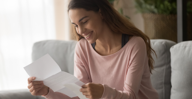 Female practitioner looking at piece of paper with a happy expression